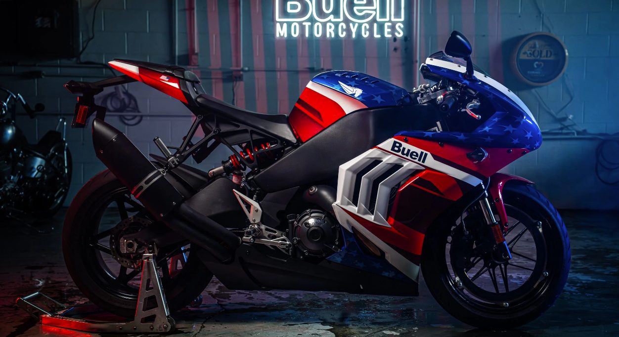Buell Hammerhead sportbike in red, white, and blue livery under a Buell Motorcycles neon sign