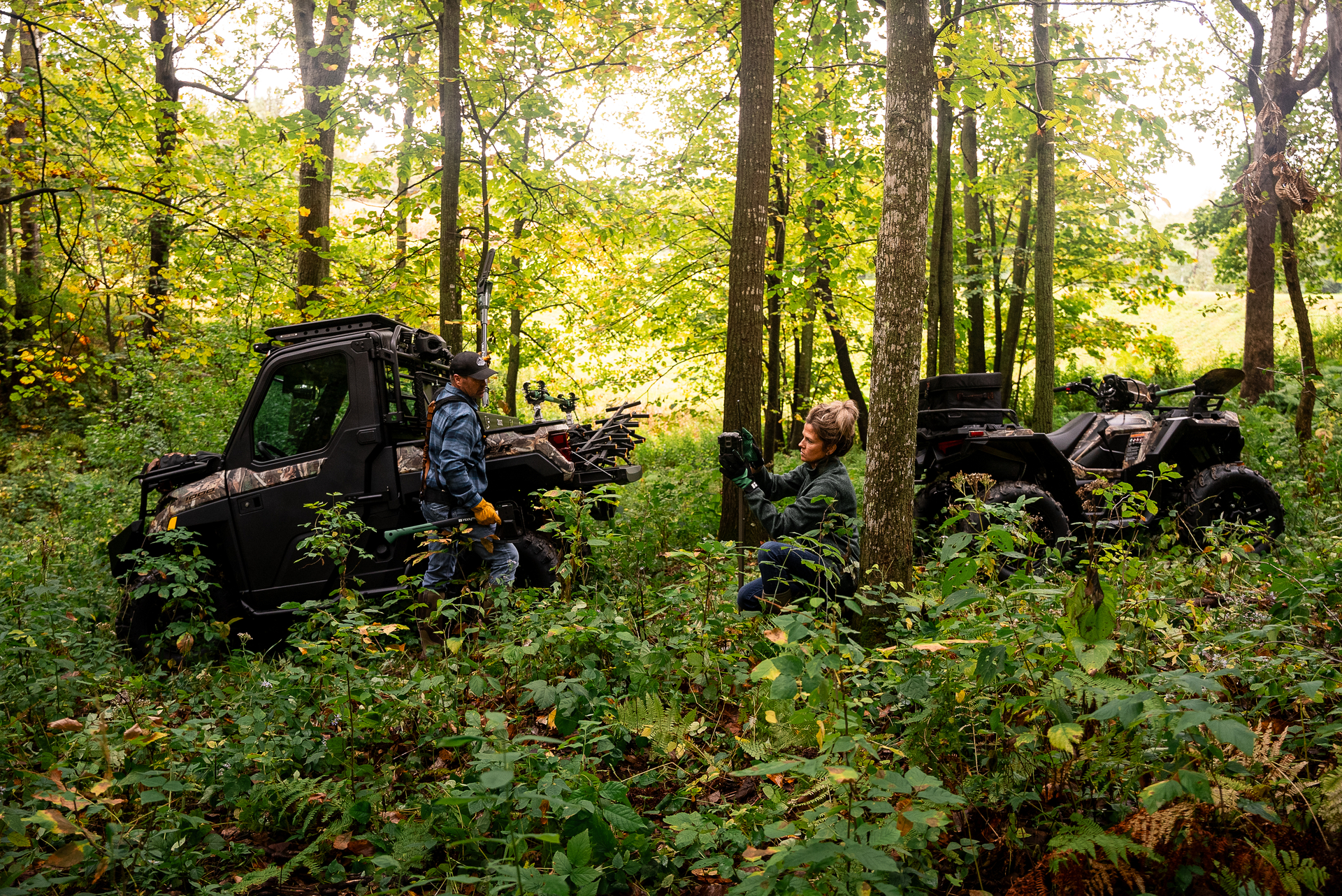 Polaris ATV and Ranger parked in the forest